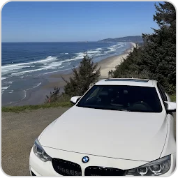 Nageeb’s white BMW at a coastal overlook