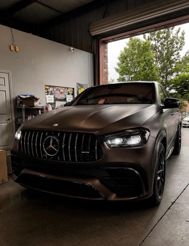 Matte brown Mercedes-AMG GLE at the German Performance shop entrance