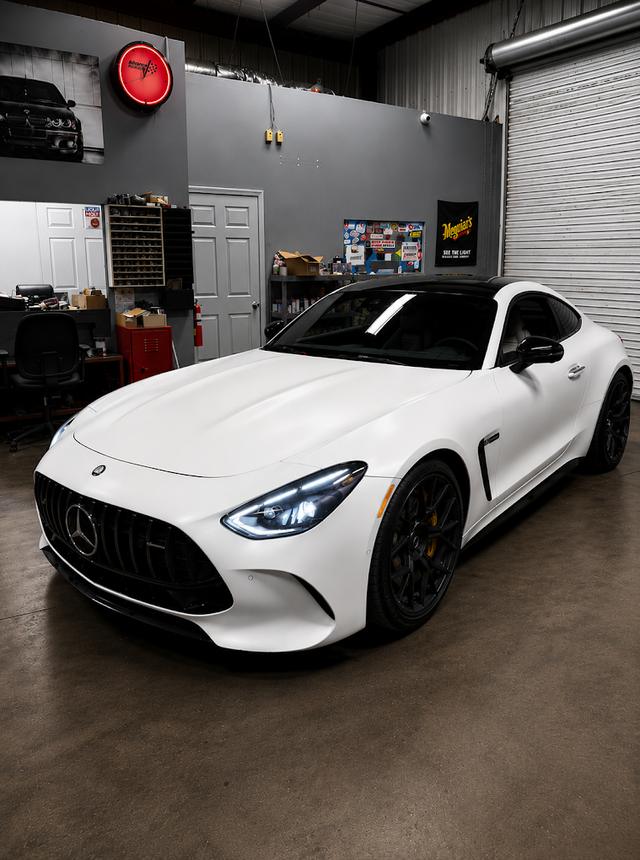 White Mercedes-AMG GT coupe inside the German Performance shop